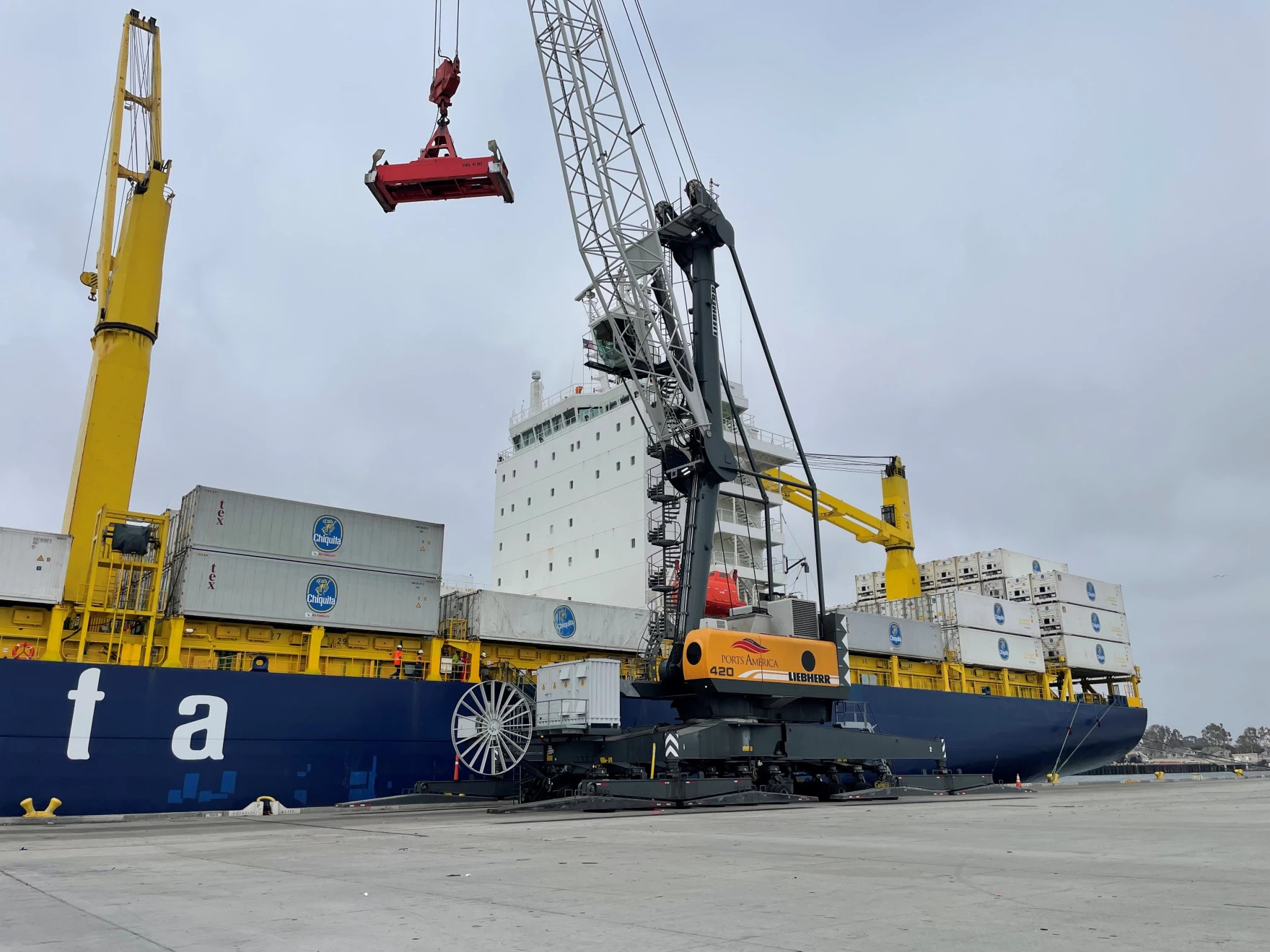 a large crane loading containers onto a large container ship in port