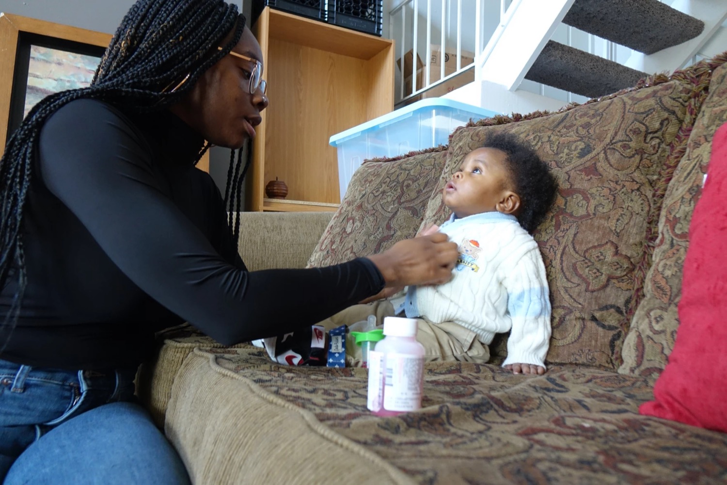 a mom cleans up a mess on her baby's shirt