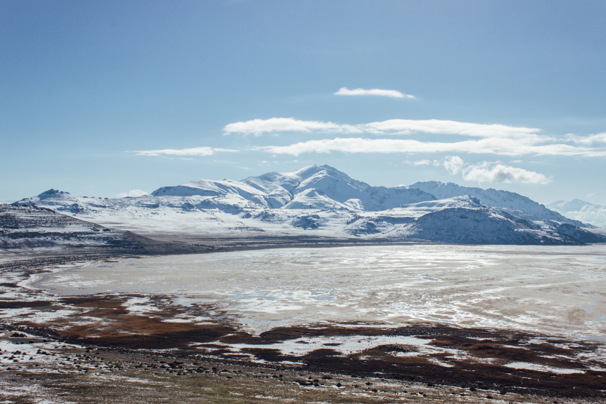 great salt lake lakebed utah, idyllic mountains in the background of a dry lakebed. Original shoreline from recent decades is on the edges of this image