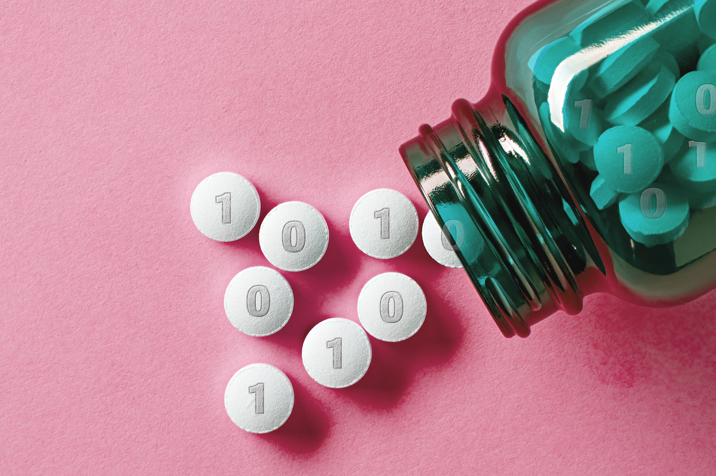 White medical pills and tablets spilling out of a drug bottle. the tablets have 1s and 0s on it, resembling binary computer code