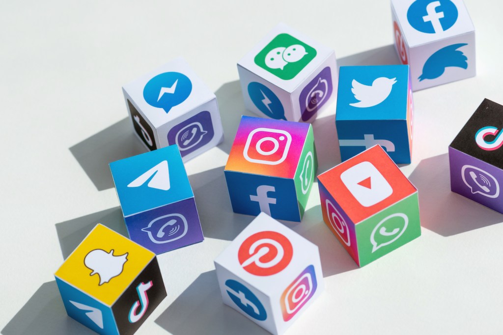A paper cubes collection with printed logos of world-famous social networks and online messengers, such as Facebook, Instagram, YouTube, Telegram and others.