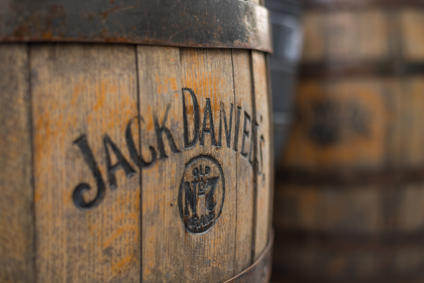 Burned logo of the famous Jack Daniel's whiskey at the old wooden barrel.