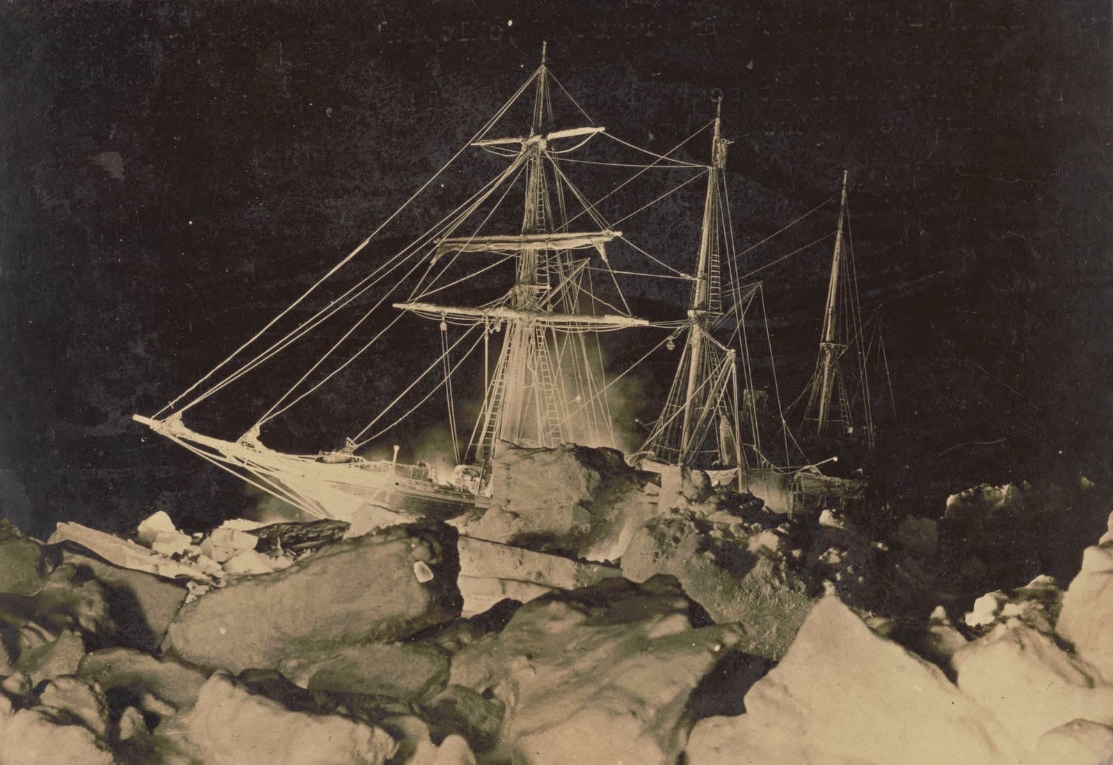 a black and white negative of a ship from an 1800s expedition stuck in antarctic ice