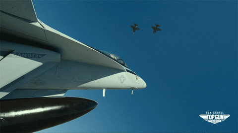 a military fighter jet pulls an incredible stunt flying between two other fighter jets, catching them by surprise