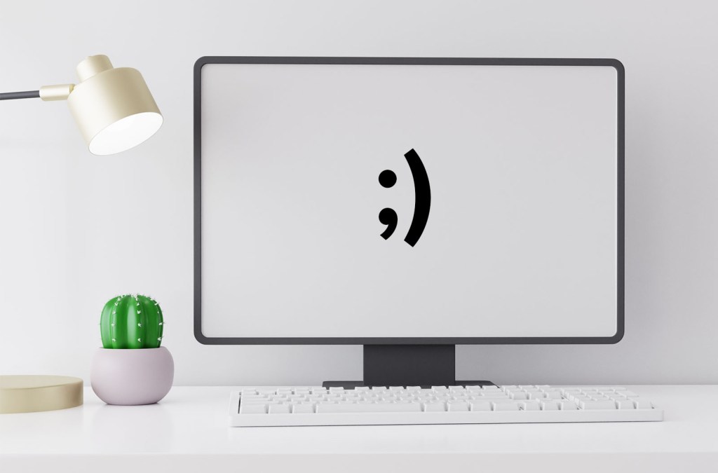 A computer screen with a winky face on it