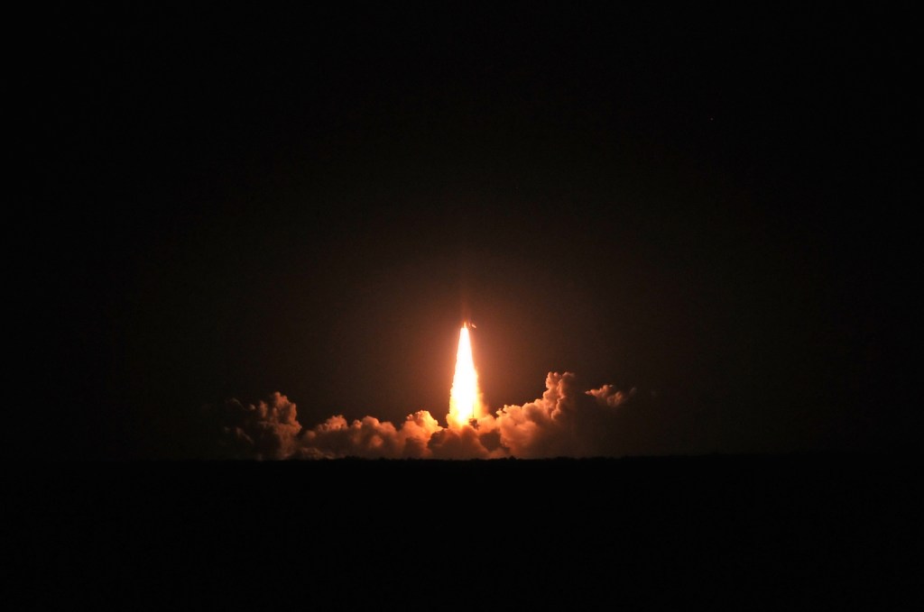 Night time launch of space shuttle