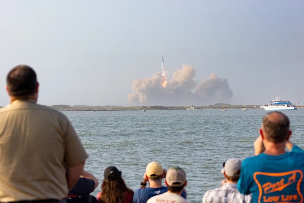 A crowd of people watching the SpaceX launch in Texas.