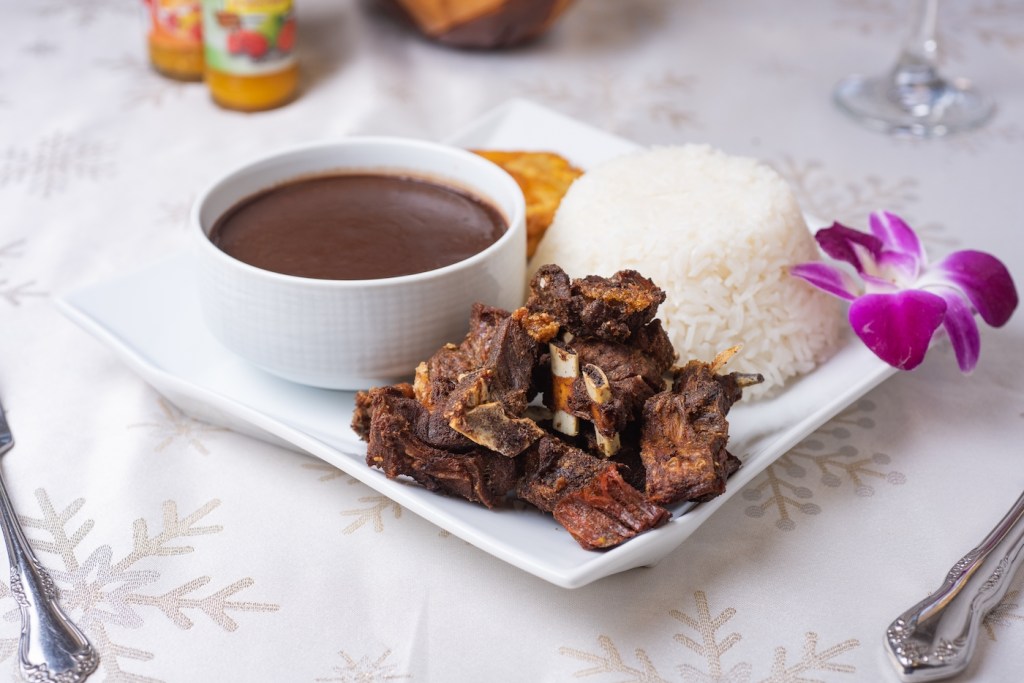 Goat and Beans and Rice Haitian Food, Antilles Cuisine, Caribbean Dining, White tablecloth