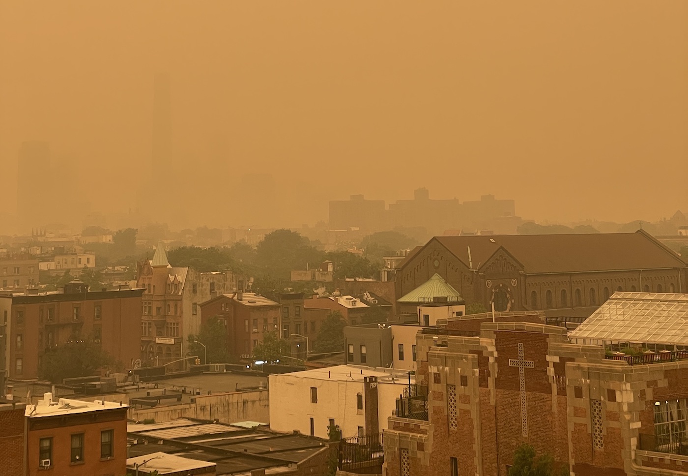 A bright orange haze covers New York City