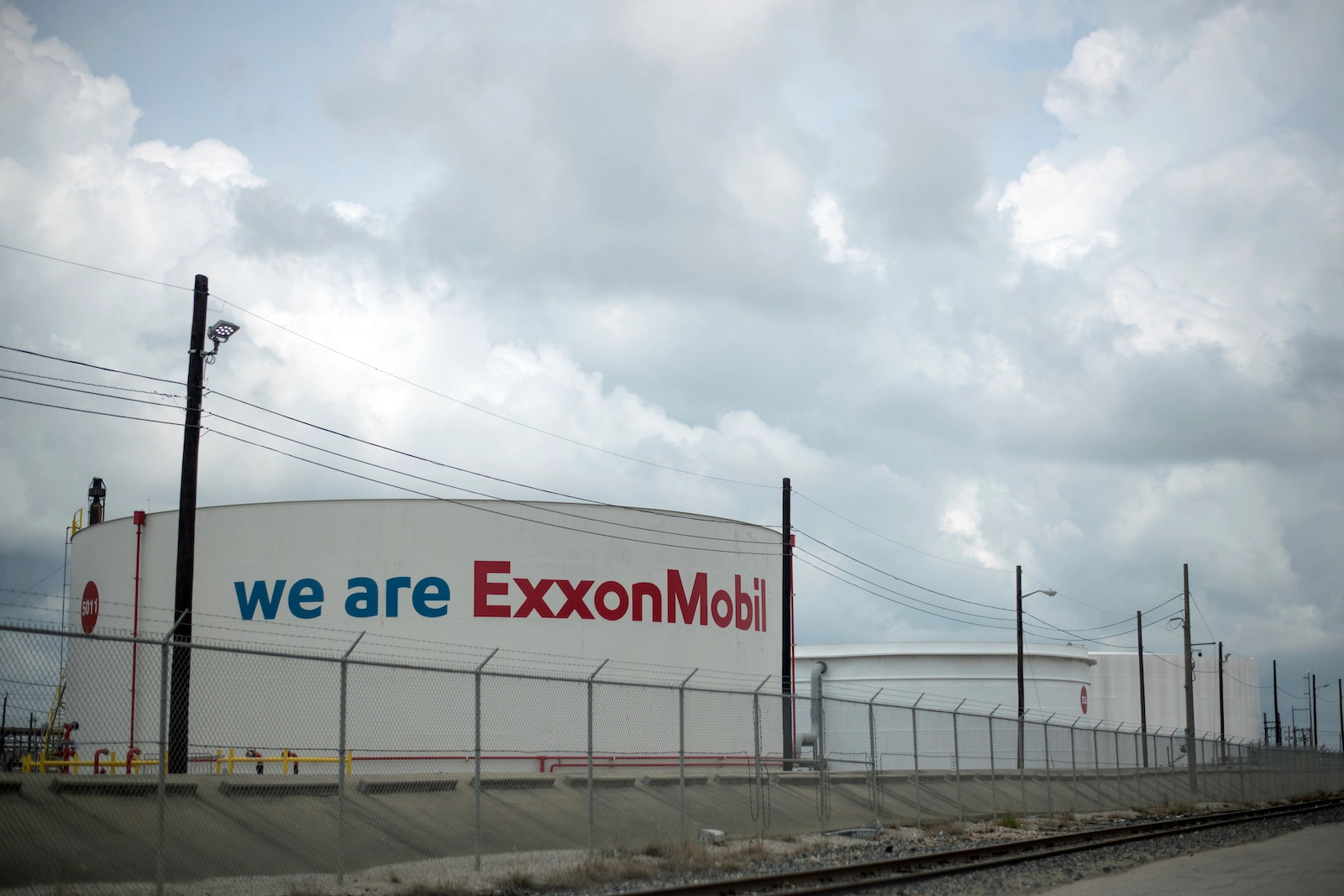 A white, barrel shaped part of the refinery that says "We are ExxonMobil" on its front.