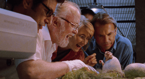 Ellie (Laura Dern) and Grant (Sam Neill) watch a baby raptor hatch in "Jurassic Park."