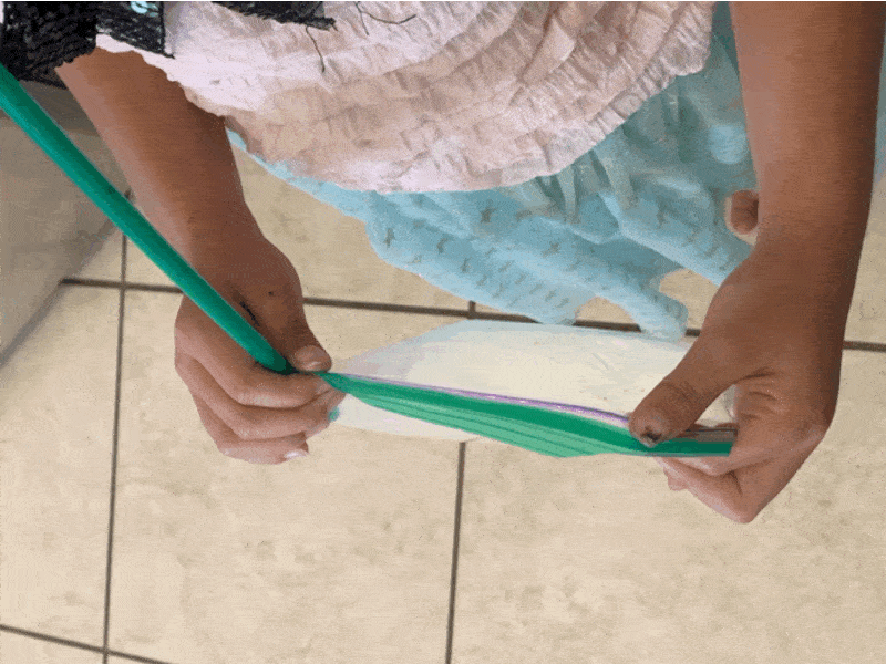 An animated gif shows a person adding and removing air to a plastic bag using a straw.