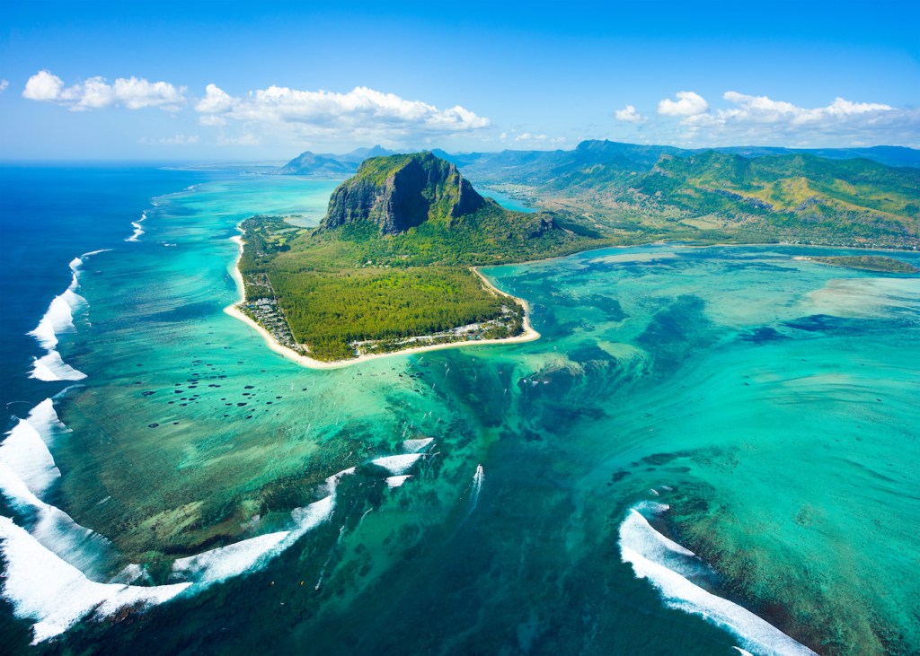 Aerial view of Mauritius island panorama and famous Le Morne Brabant mountain, beautiful blue lagoon and underwater waterfall.