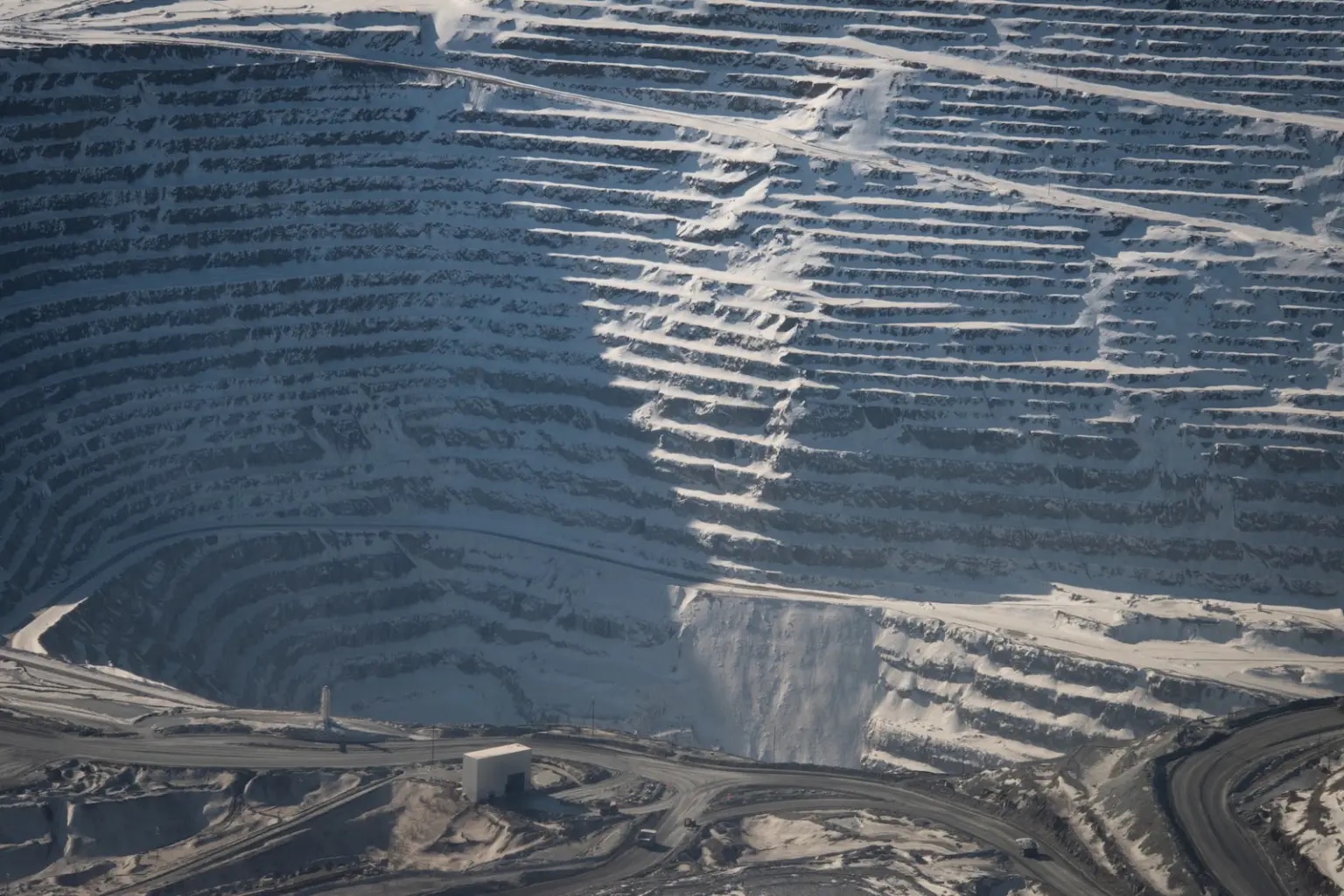 A huge mining quarry, powdered with snow.