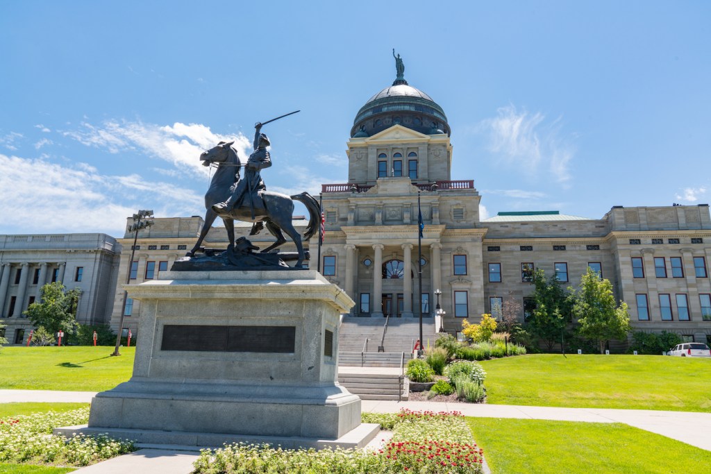 A statue of a man on a horse in front of a law building