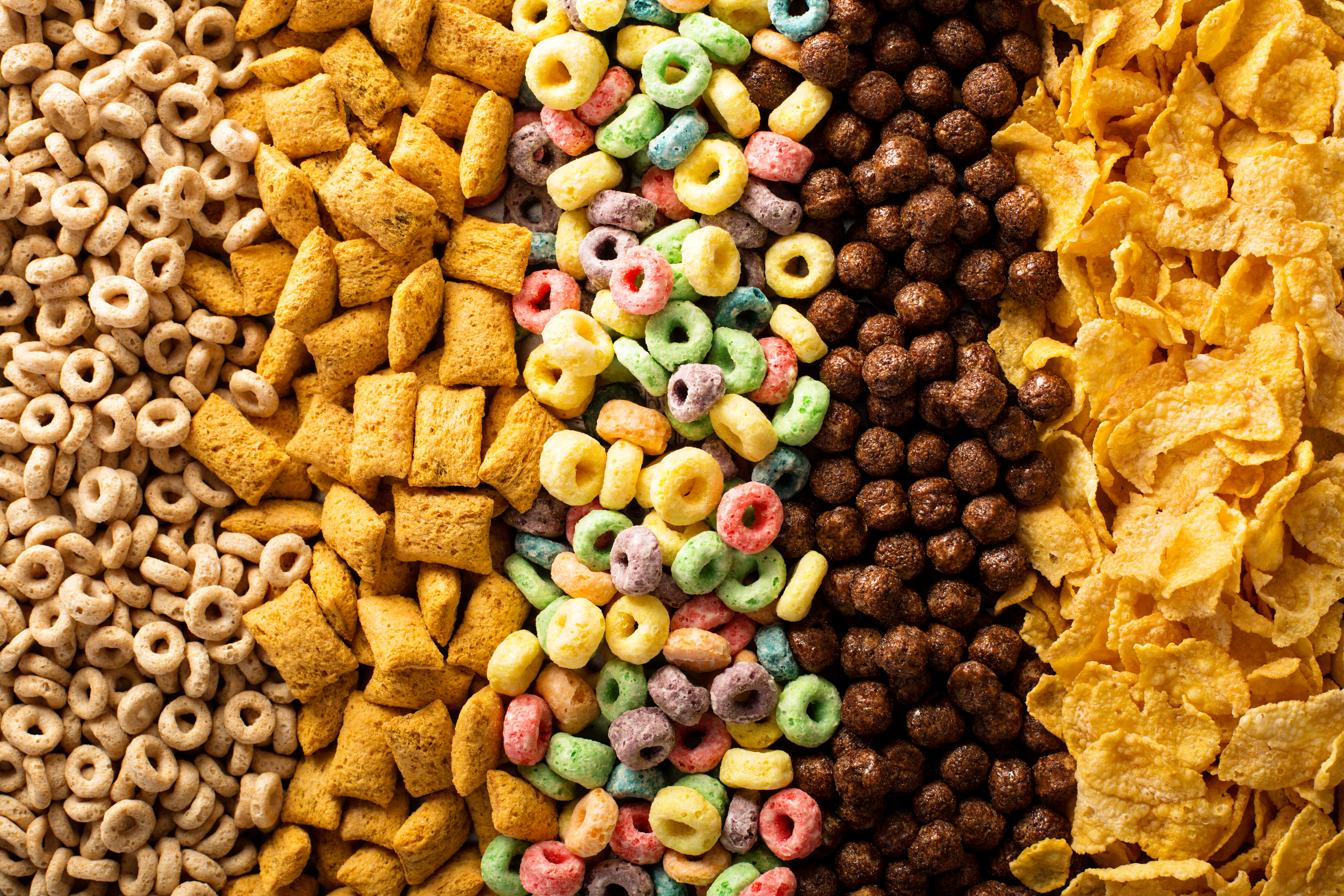 Variety of cold breakfast cereals arranged in vertical lines.