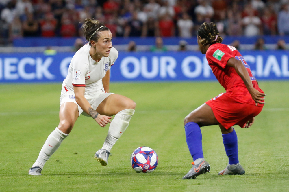 two female soccer players face off