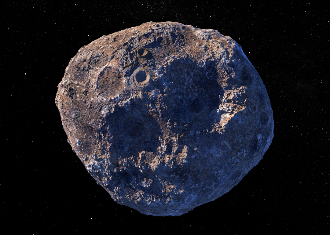 A 3-d rendering of a metal asteroid covered in craters.