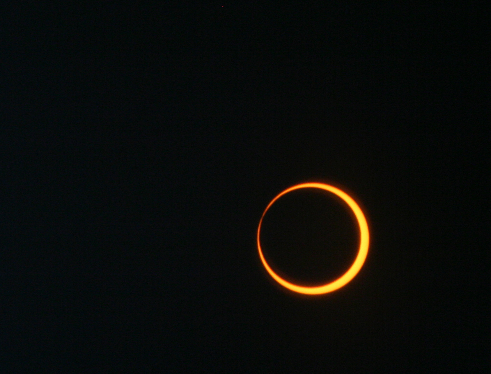 A thin ring of yellow against a black background