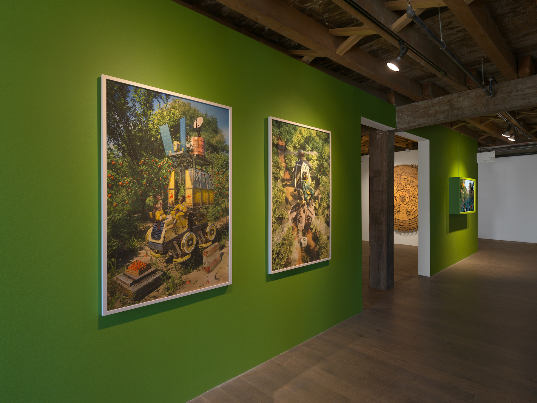 A green wall adorned with paintings of gardens and garden tools.