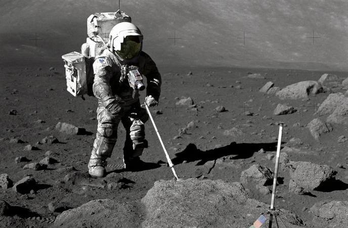 A person in a space suit with a probe standing on the moon.