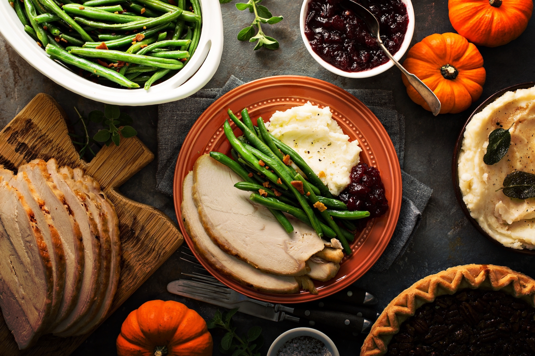 Thanksgiving plate with turkey, mashed potatoes, green beans and cranberry sauce