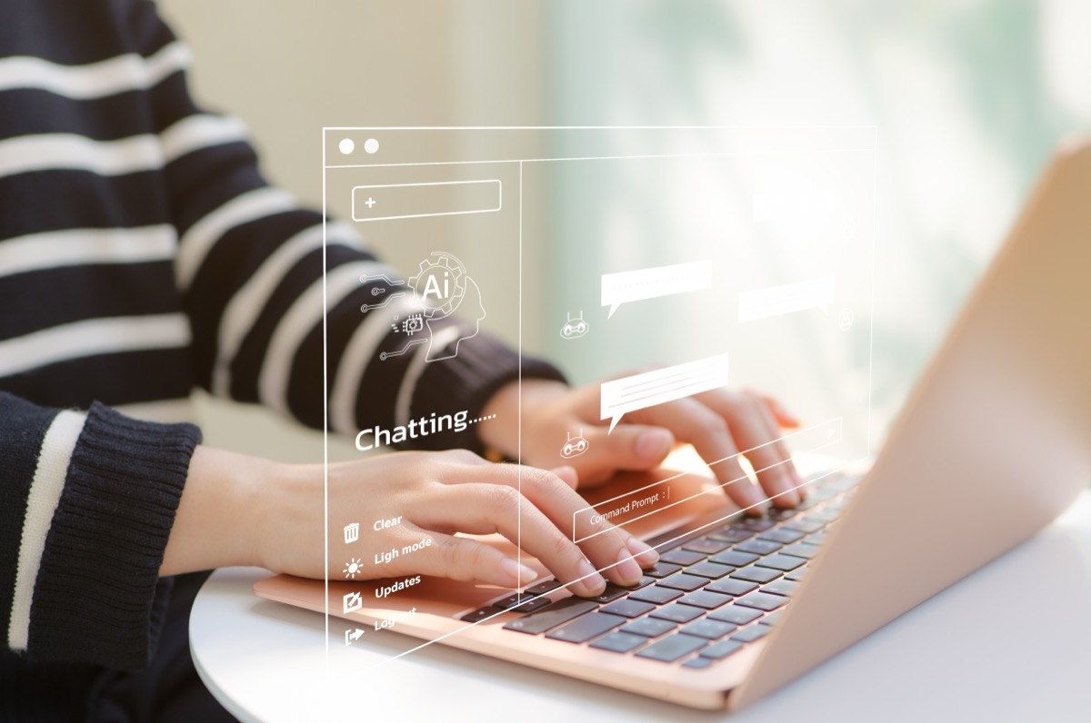 A woman using a computer and chatting with an artificial intelligence