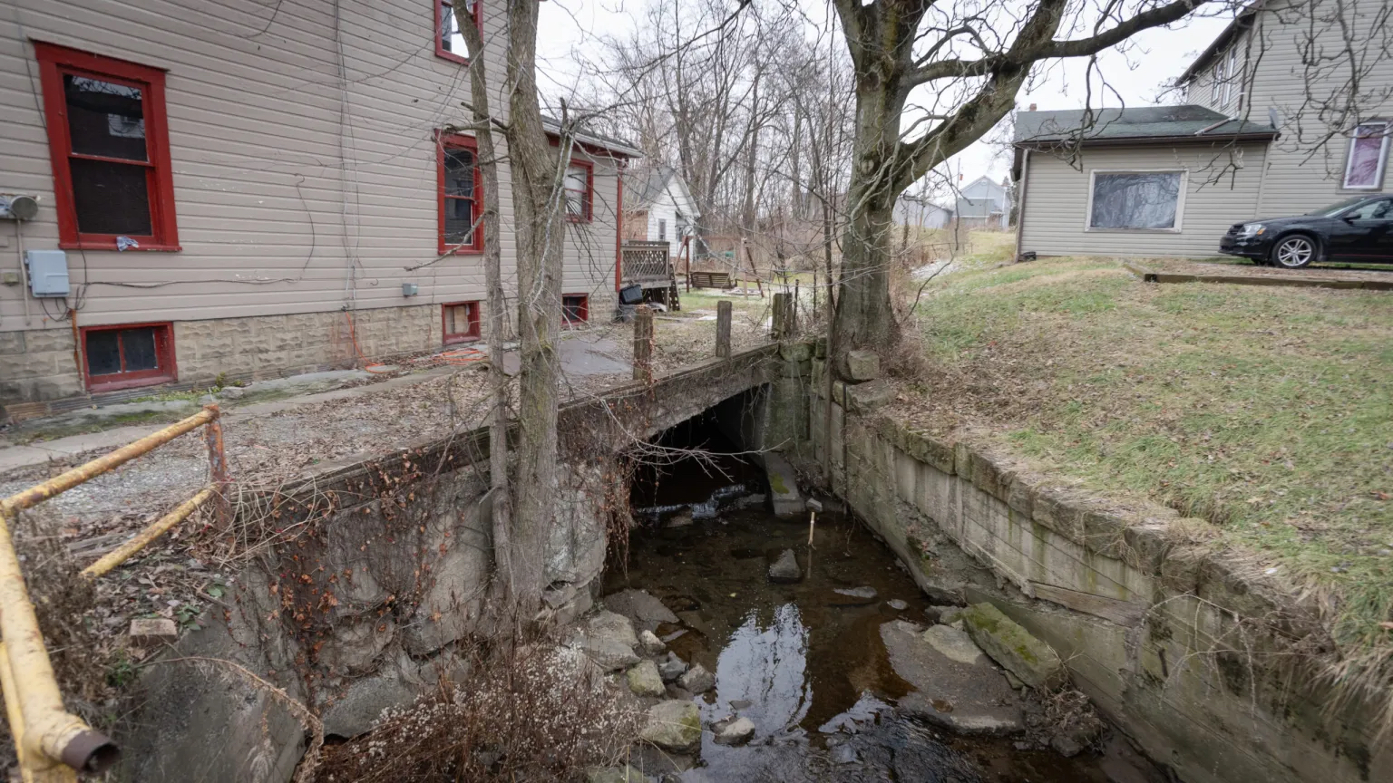 A stream running under a system of houses