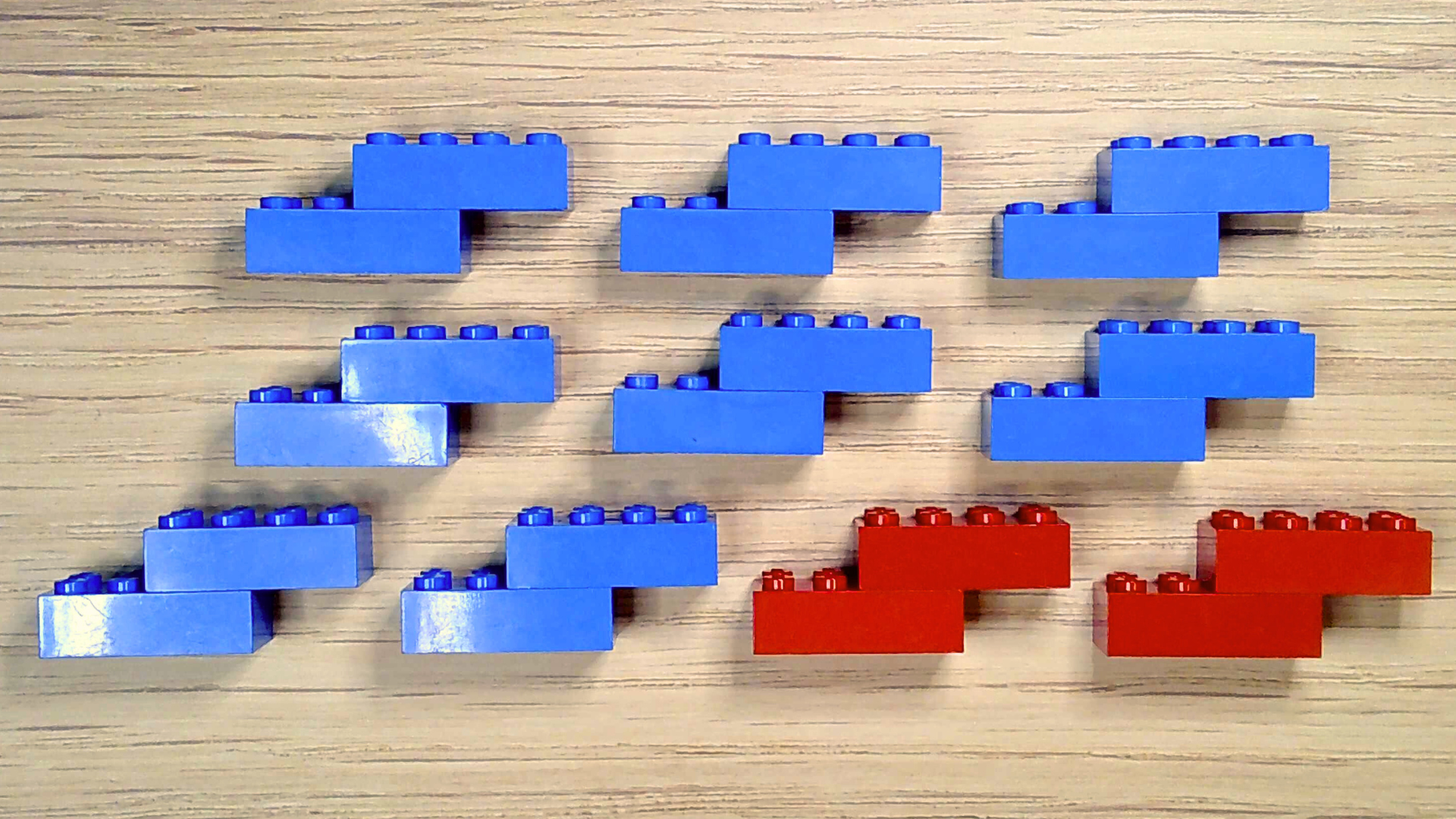 A group of eight blue nitrogen brick models and two red oxygen brick models.