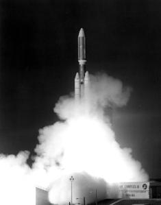 A black and white photo of a rocket launching into space