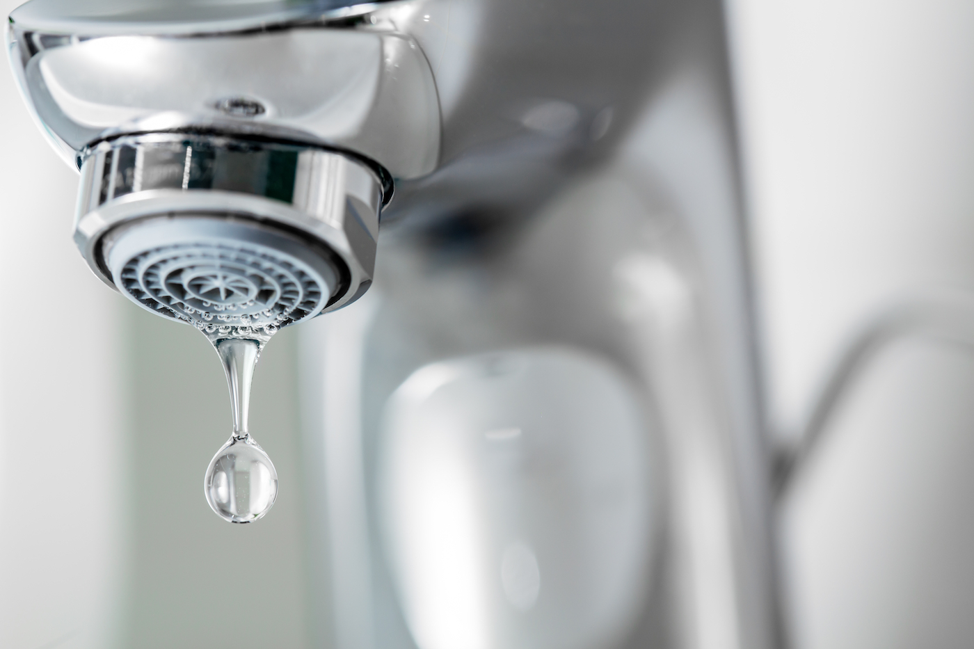 Tap closeup with dripping water-drop. Water leaking, saving concept.