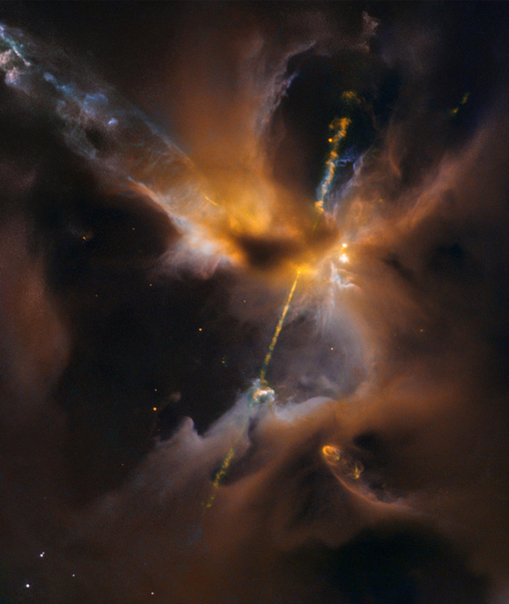 A jet of orange light passes through dark clouds in space.