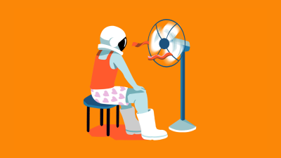 An astronaut wears their helmet, boots, and undergarments as they sit in front of a blowing fan.