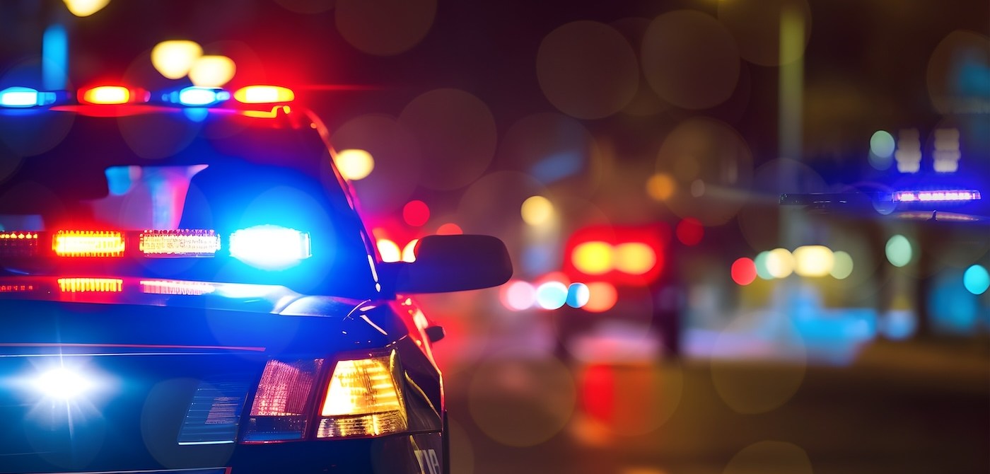 Police cars at night. Police car chasing a car at night. 911 Emergency response police car speeding to scene of crime. Selective focus on cars. Road design