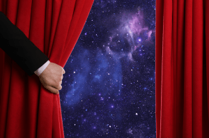 A person pulling back a red curtain, revealing the mysteries of space.