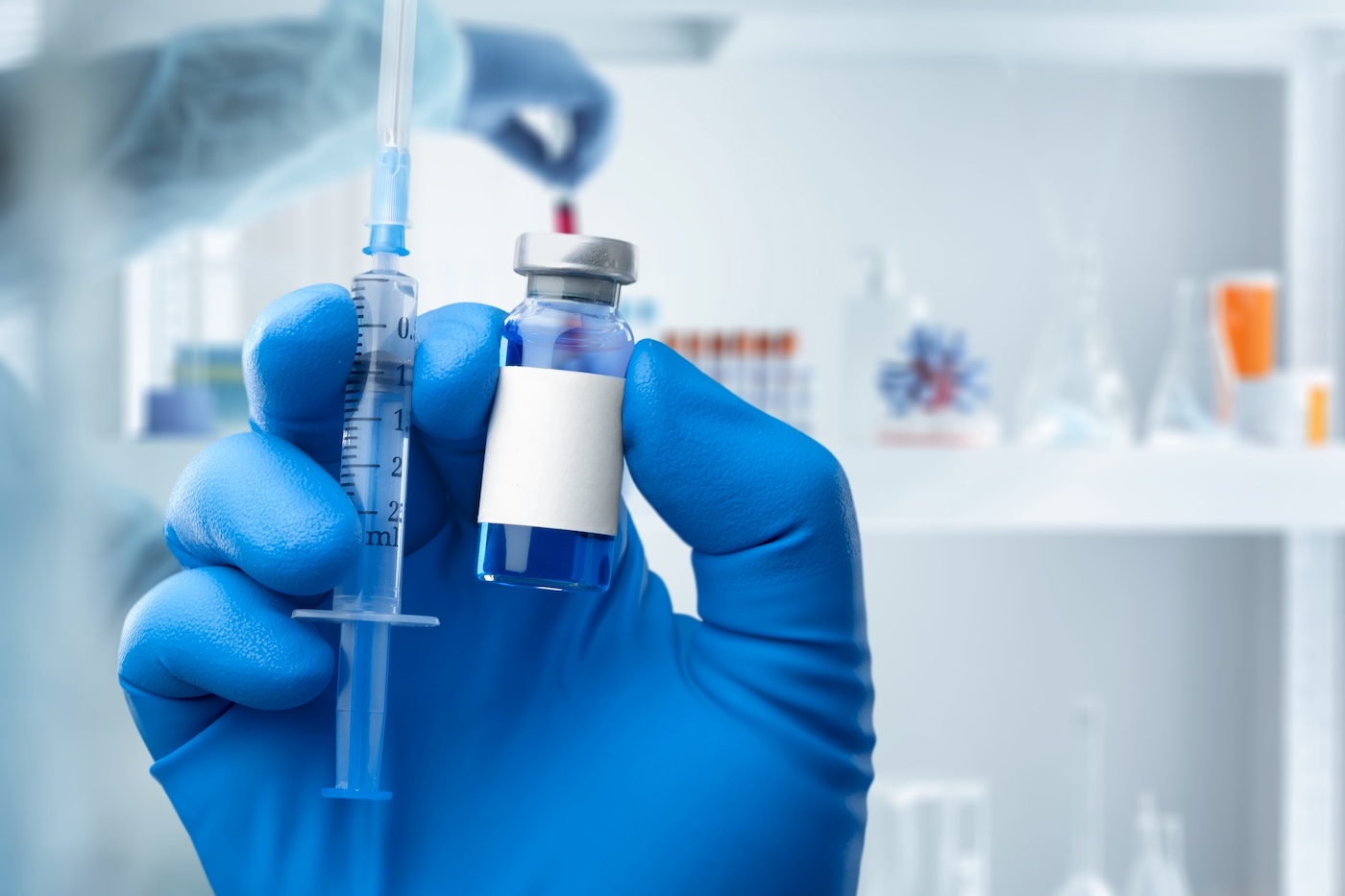 Medical worker filling a syringe with vaccine booster, universal vaccine