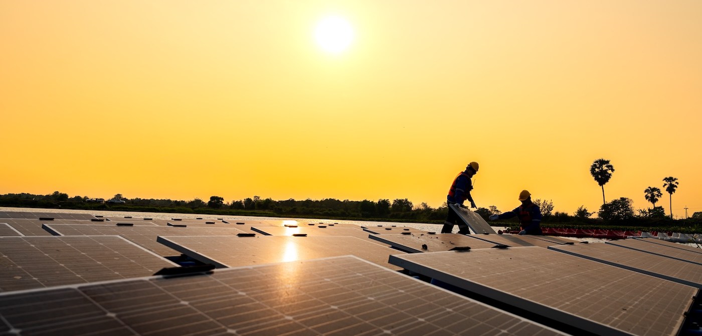Photovoltaic engineers work on floating photovoltaics. workers Inspect and repair the solar panel equipment floating on water. Engineer working setup Floating solar panels Platform system on the lake.