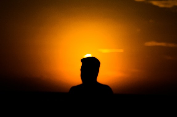 A dark figure stands silhouetted against the setting sun a quiet moment of solitude and contemplation. neuroscience, memory