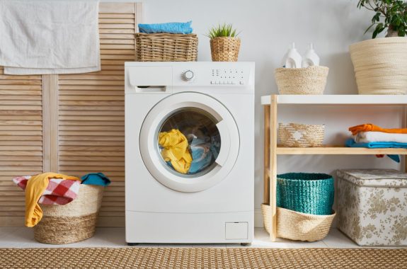 Interior of a real laundry room with a washing machine at home