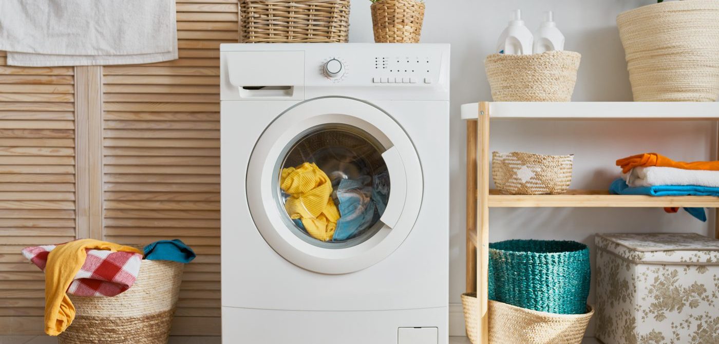 Interior of a real laundry room with a washing machine at home