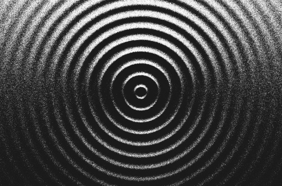 Stippling artwork with concentric circles geometry expand in rhythmic harmony.