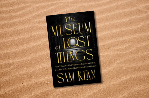 A book cover set against a closeup of sand.