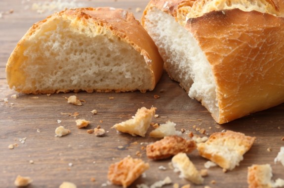 A photo of bread, with crumbs next to it
