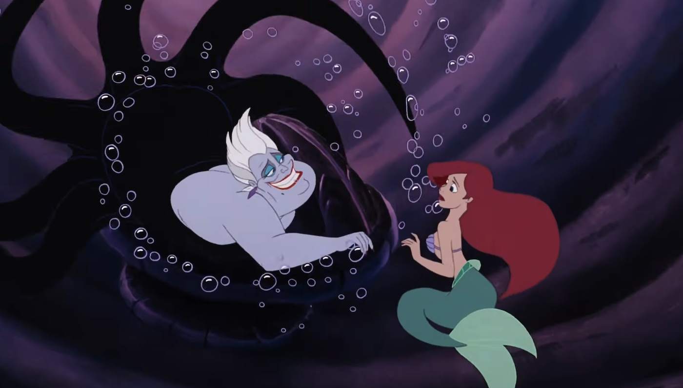 An animated sea witch with tentacles swirling behind her while she smiles at a mermaid with red hair